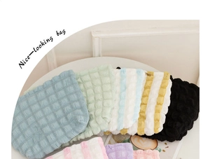Various colors of puffy bubble textured makeup bags with canvas storage details