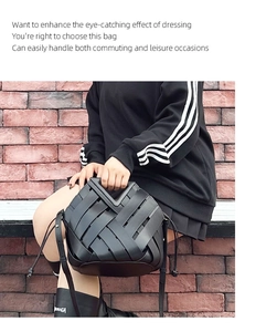 Detailed view of a black woven leather tote bag shown in a professional lifestyle setting