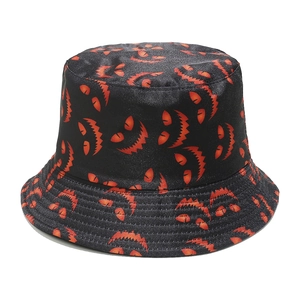 Detailed view of black bucket hat featuring orange Halloween monster print and stitching