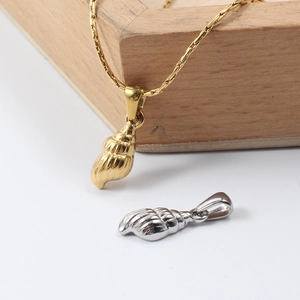 Detail view of gold and silver conch shell pendants with high-quality metallic textures