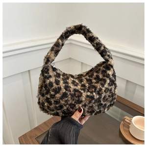 Detailed view of the leopard print plush texture and zipper closure on the hobo bag