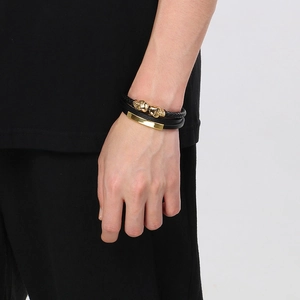 Men's double-layer black leather bracelet with gold skull charms and magnetic clasp