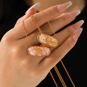 Gold stainless steel ocean-inspired necklace with oval shell pendant and inlay