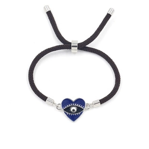 Close-up of woven rope bracelet featuring a dark blue enamel heart and evil eye charm