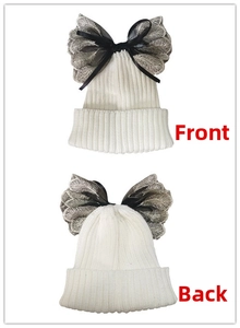 Detailed front and back views of a white knit beanie with gold-embroidered tulle bow