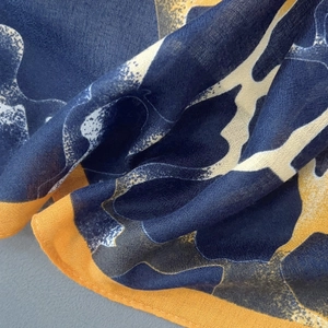 Macro shot of abstract navy and yellow pattern on lightweight linen blend scarf fabric