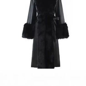 Women's black long winter coat with faux fur trim and waist belt on white background