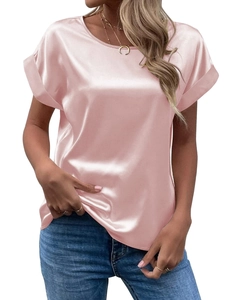 Detail shot of elegant pink satin fabric showing its smooth glossy texture and round neckline