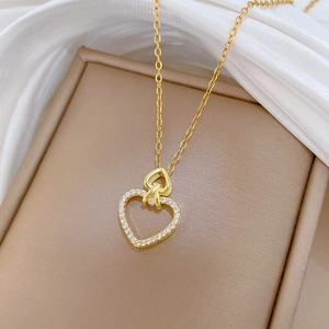 Luxurious gold titanium necklace with double heart pendants and pavé crystal accents