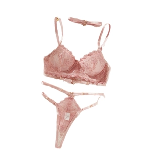 Pink lace lingerie set with push-up bra, thong, and heart buckle choker on white background