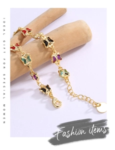Detail of colorful butterfly gold plated bracelet with lobster clasp and extension chain
