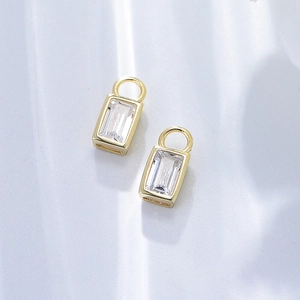 Macro view of gold plated 925 silver square zircon drop earrings with emerald cut crystals
