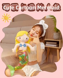 Close-up of a mermaid plush doll featuring sequins fish tail and yellow hair
