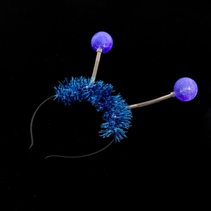Detail of alien antenna headband with purple glitter balls and blue metallic tinsel