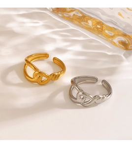 Macro detail of gold and silver crossover rings with elegant water ripple light effect