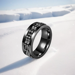 Close-up detail of black titanium steel stress-relief ring with rotating gear design