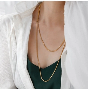 Elegant double-layered gold snake chain necklace for women shown on a model