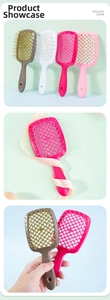 Close-up of hollow hair brushes in brown, white, and pink with ergonomic handles