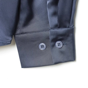 Elegant dark blue satin shirt with double button cuffs and smooth glossy silk texture