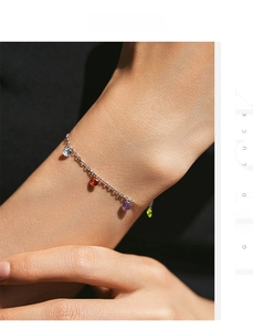 Detailed close-up of s925 silver bracelet featuring vibrant multicolor crystal pendants on wrist