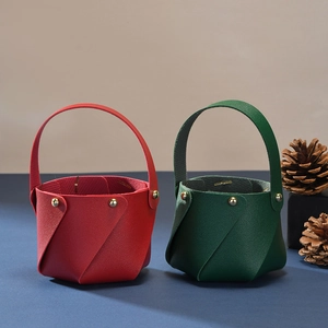 Detail view of red and green leather Christmas gift baskets with gold rivets