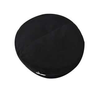 Close-up of black wool beret with cross seam stitching and silver metal accent detail