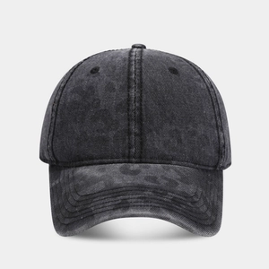 Detailed macro view of washed dark gray cotton fabric texture on a camouflage baseball cap