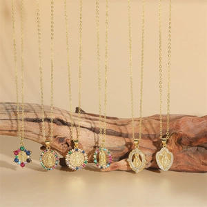Gold Virgin Mary necklaces with colorful zircon pendants on natural wood background