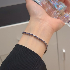 Close-up of elegant silver bracelet with marquise-cut deep purple gemstones on wrist