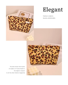 Detail of leopard print corduroy makeup bag showing fabric texture and brand label