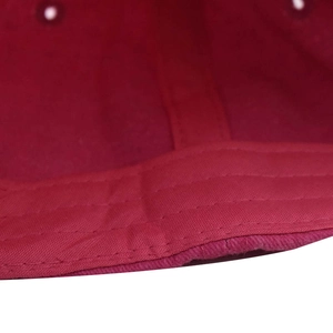 Detail view of red washed cotton baseball cap inner sweatband stitching and eyelets