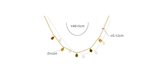 Detailed view of colorful pear-cut zircon pendants on a golden bead chain necklace