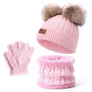 Pink winter knit set featuring double pom pom beanie, neck warmer, and cozy gloves