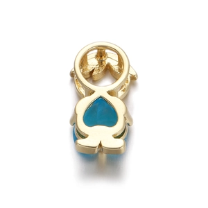 Detailed view of a gold boy-shaped pendant with a sparkling blue faceted zircon stone