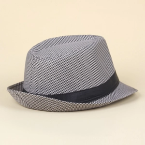 Detailed close-up of a houndstooth jazz fedora with a black decorative ribbon strap