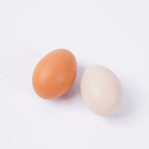 Realistic artificial egg models in brown and beige colors on a clean white background