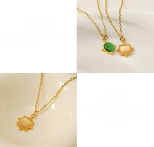 Detail of 18K gold stainless steel necklaces with green stone and white opal pendants