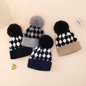 Winter checkered knit infant beanies with large pom-poms in various colors