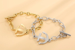Detail of silver and gold anchor bracelets with textured links and OT toggle clasps