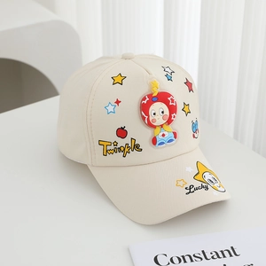Detail of beige cotton baby baseball cap with colorful star embroidery and cartoon patch