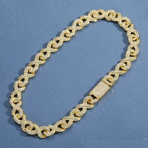 Macro view of gold hip-hop necklace featuring crystal-encrusted infinity links