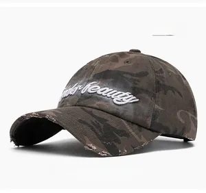 Detail of 3D Beauty embroidery and distressed edge on washed camo baseball cap