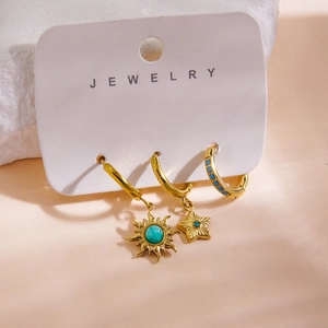 Detail of 14K gold-plated earring set featuring turquoise stones and celestial charms