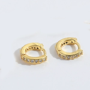 Detail of 925 sterling silver gold hoop earring with micro-set cubic zirconia accents
