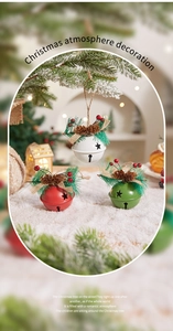 Close-up of Christmas bell ornaments with pine cones, red berries and star cutouts