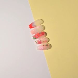 Detail of rose embossed nail charms with 3D floral petals and pearl accents on pink nails