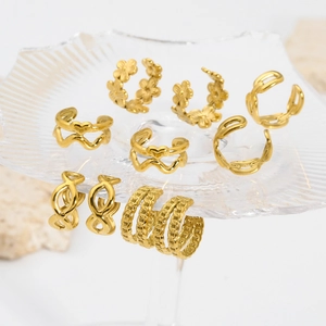 8-piece set of gold stainless steel ear cuffs featuring floral and geometric designs