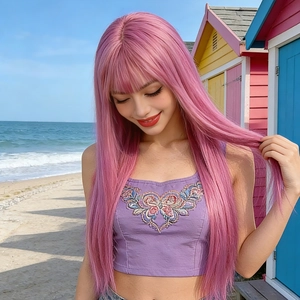 Pink long straight wig with bangs worn by model at beach with colorful houses