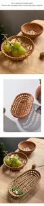 Macro detail of hand-woven rattan storage trays and coasters on a wooden table surface