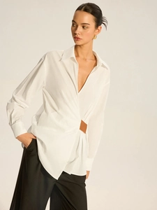 Women's white long sleeve shirt with asymmetrical waist pleats and brown buckle detail